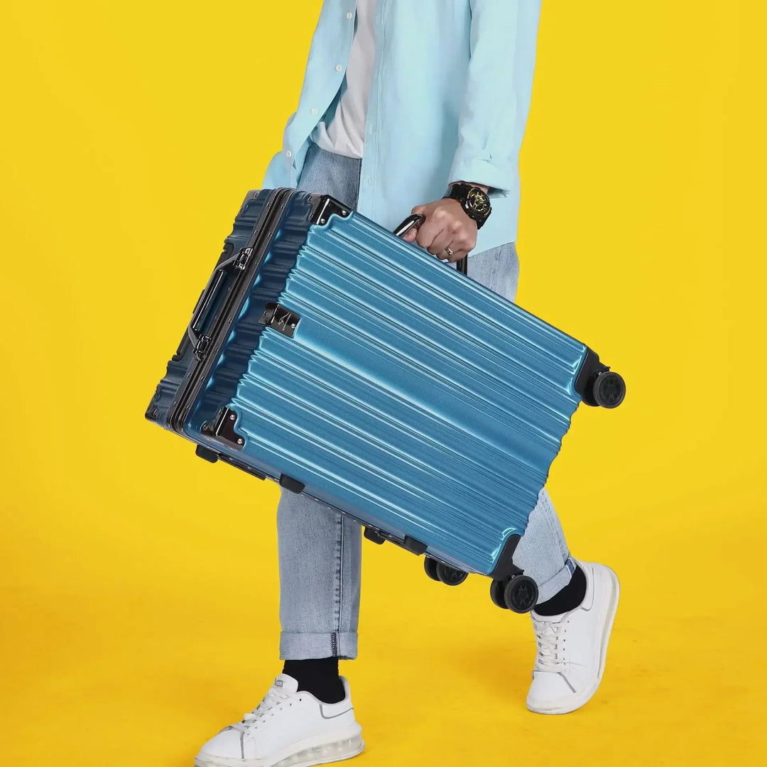 Sleek black hardshell travel bag, unisex, featuring a contemporary aluminum frame design & smooth rolling wheels.