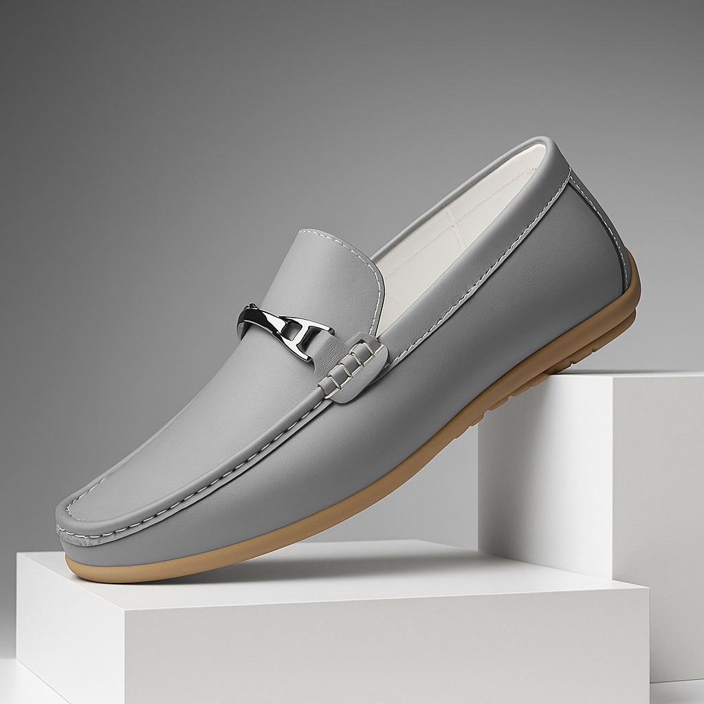 Close-up of a unisex brown leather loafer, showcasing fine leather texture and stitching detail.