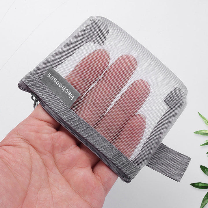 Close-up of a black mesh zipper pouch, showcasing its breathable and durable material.