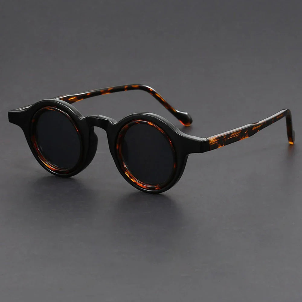 Fashionable unisex round sunglasses with thick frames, providing excellent UV protection for all-day wear.