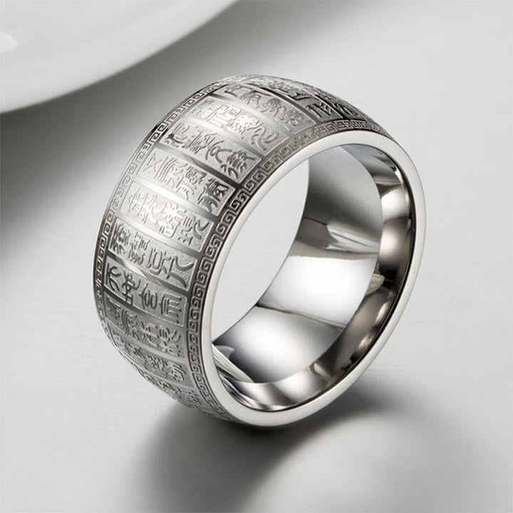 Close-up of a golden titanium ring with clear Buddhist mantra inscription, ideal spiritual gift