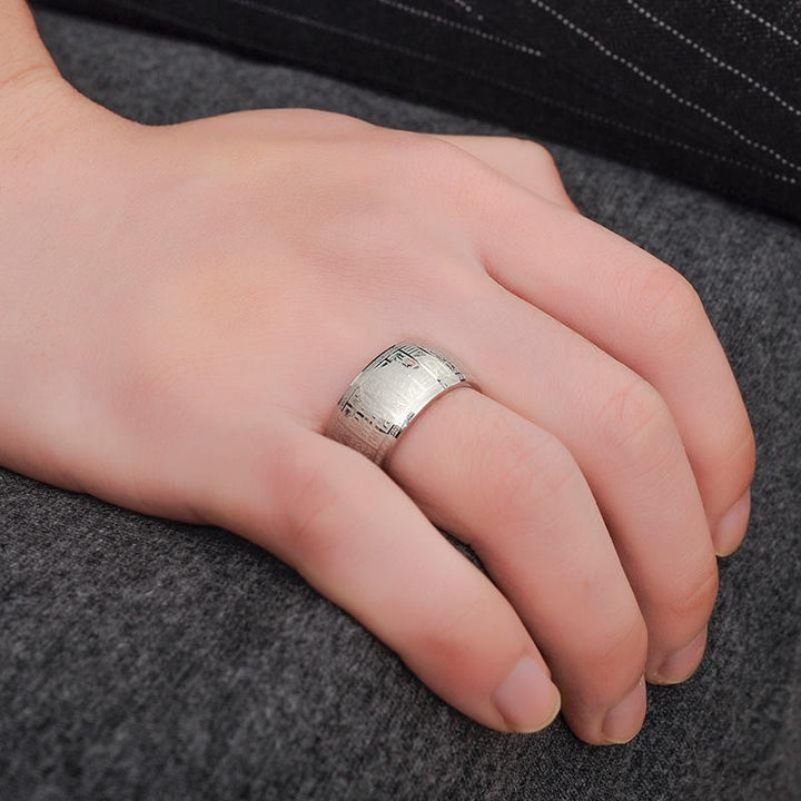 A stack of silver and golden Buddhist mantra rings, titanium steel, symbolizing serenity and good luck