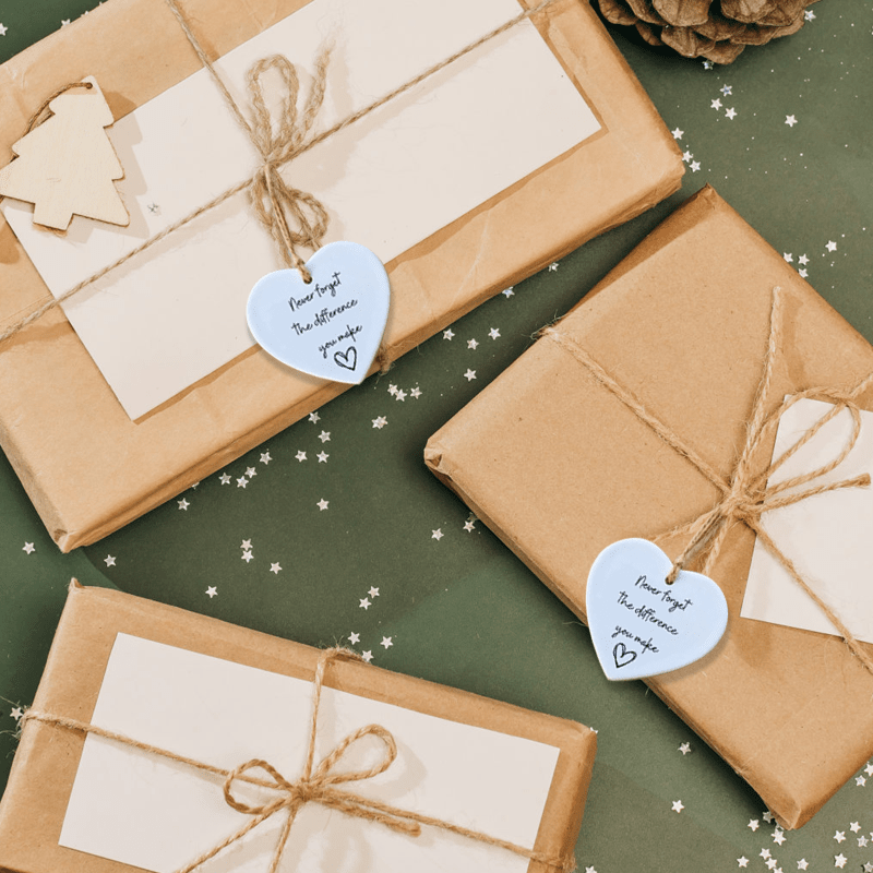 Heart-shaped ceramic decor item featuring an uplifting quote, suitable for unisex gifting and emotional connection.