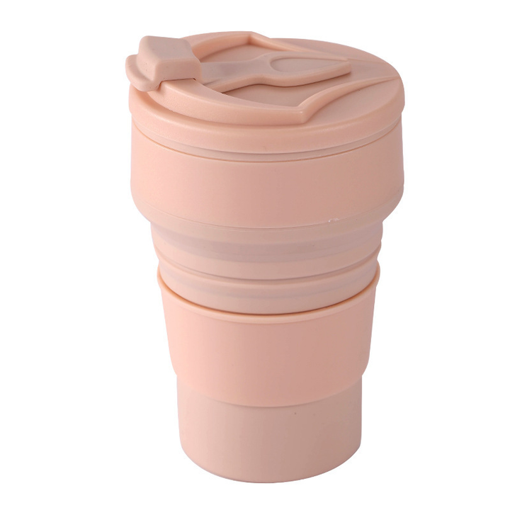Compact silicone water bottle, green, folded for storage, an eco-friendly travel solution
