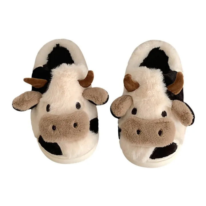 Close-up of fluffy black & white cow plush slipper, soft unisex novelty footwear for comfy home use.