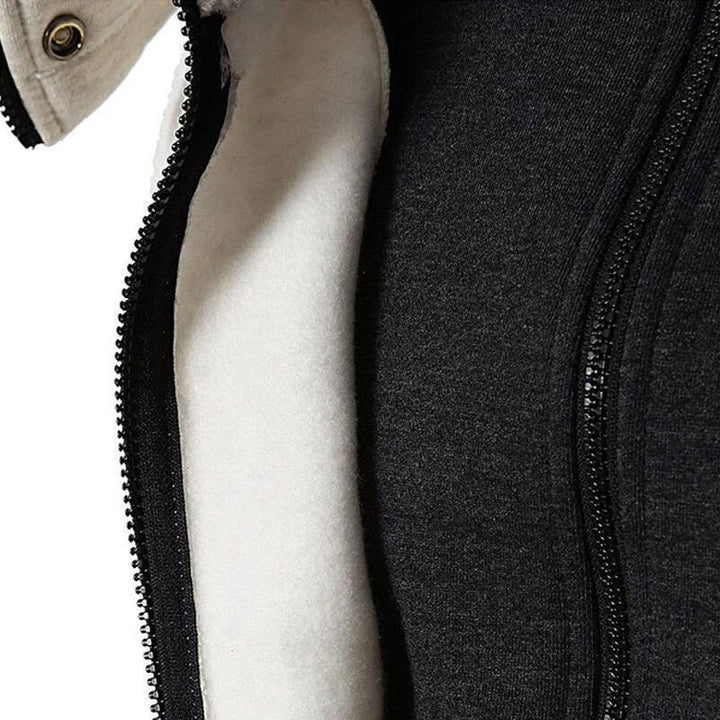 Stack of folded cozy unisex jackets in various neutral autumn colors
