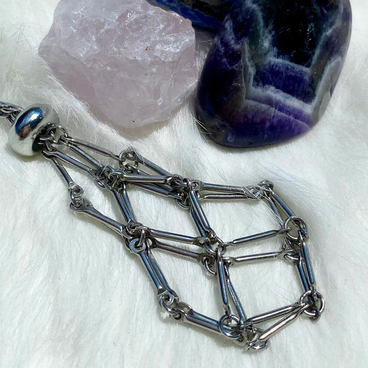 Model wearing a silver crystal cage pendant necklace, showcasing size and fit, healing stones