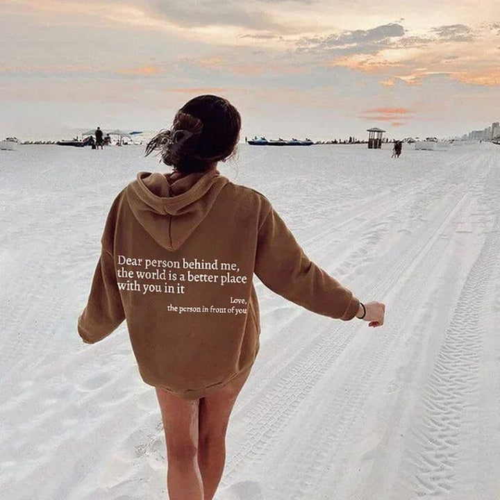 Lifestyle shot of 'Dear Person Behind Me' sweatshirt with coffee, comfort wear vibes