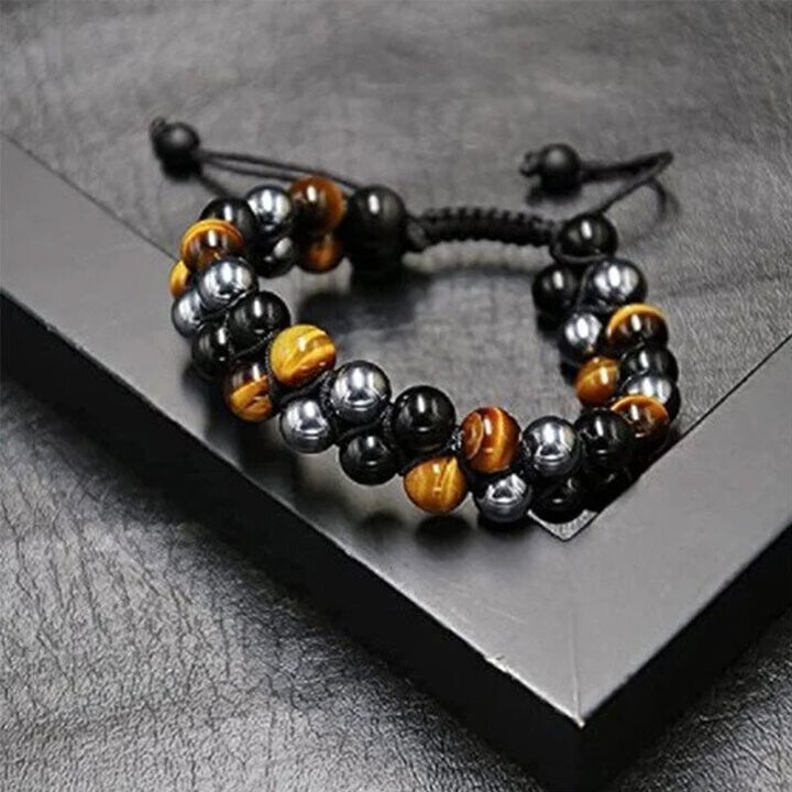 Unisex gemstone bracelet combining tiger's eye, obsidian, and hematite, offering protection and style.