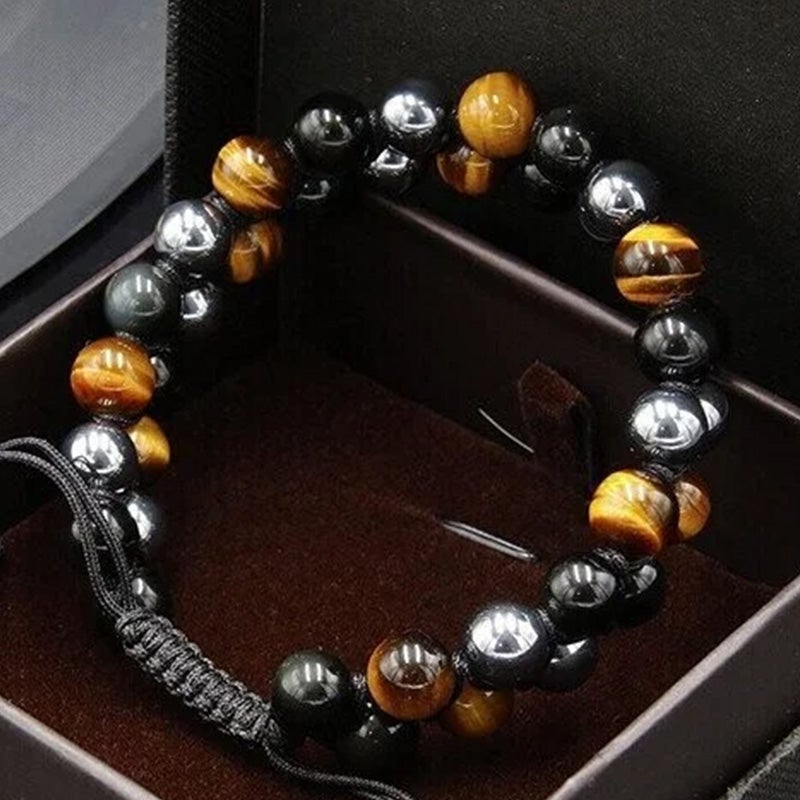 Detail shot of the polished tiger's eye, obsidian, and hematite beads on a unisex protection bracelet.