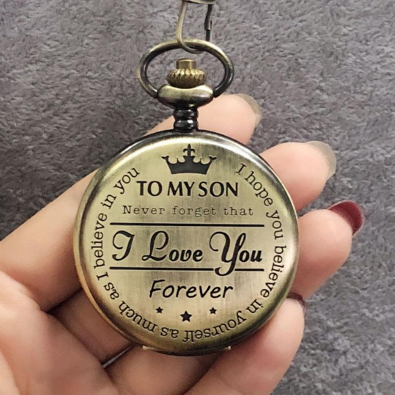 Side view of a thin engraved quartz pocket watch in silver, a sophisticated mens accessory