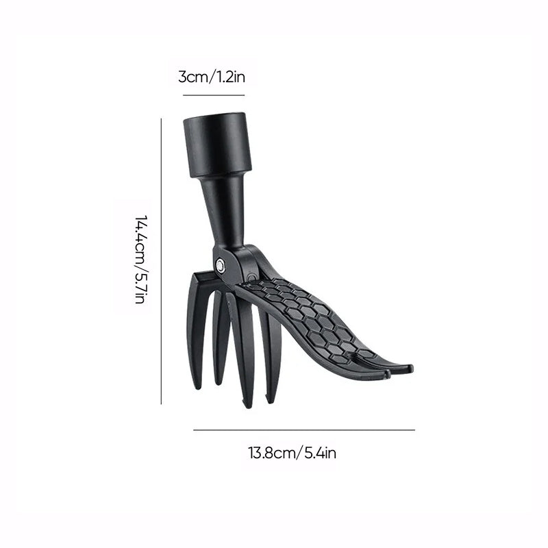 The detachable weed puller tool propped against a garden fence, ready for lawncare duty