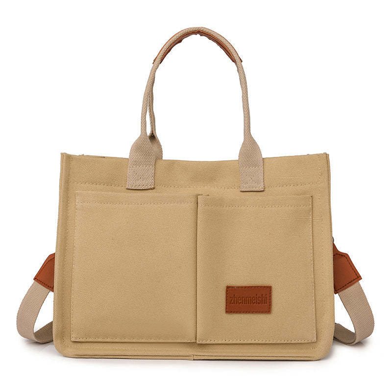 Sturdy canvas travel bag, easily convertible to a shoulder bag for convenient carrying.