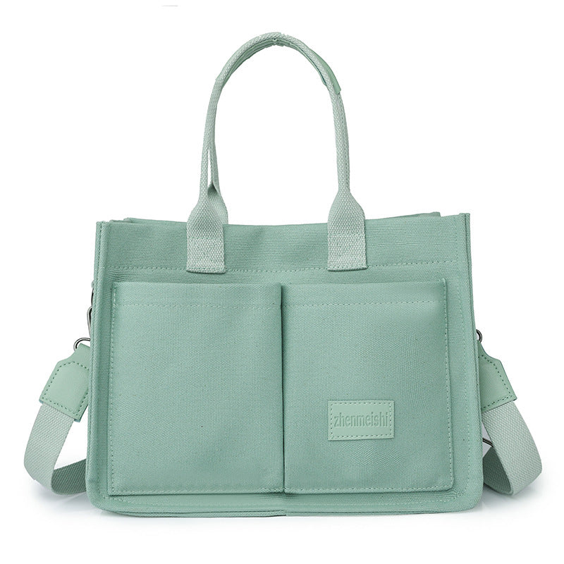 Fashionable unisex bag, a durable canvas crossbody with a secure flap closure.