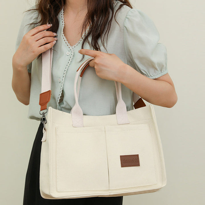 Close-up of the canvas texture on a unisex crossbody bag, highlighting its quality material.
