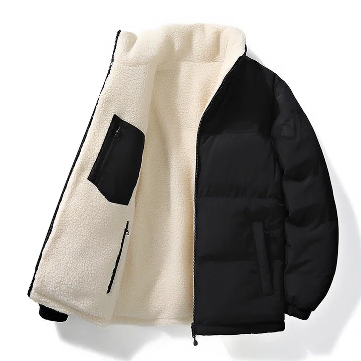 A stack of folded unisex puffer jackets, showcasing various solid colors available for winter outfitting.