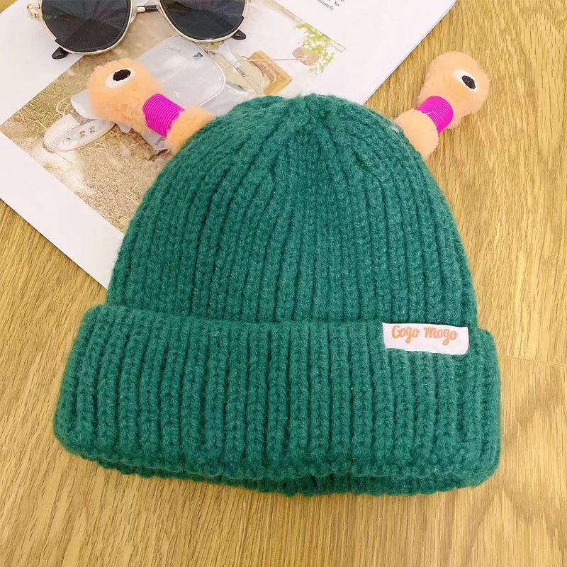 Green knit monster hat with playful eyes, a fun accessory for anyone