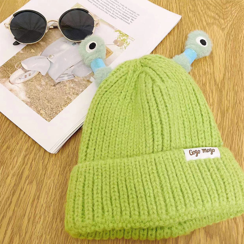 Group of friends wearing assorted Monster Knit Beanies, having fun