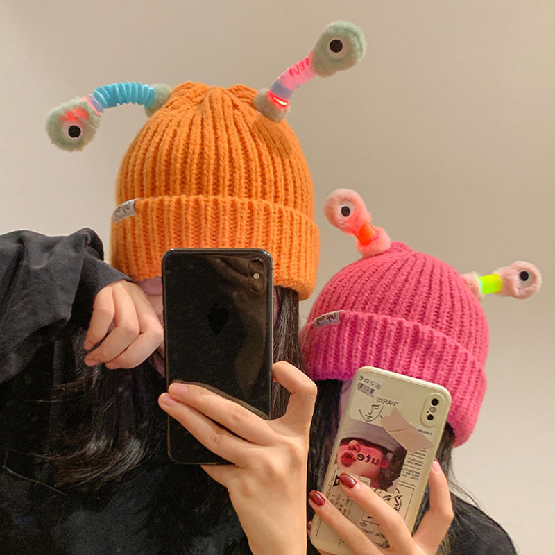 Teenager modeling a purple Monster Knit Beanie, ideal for cold weather