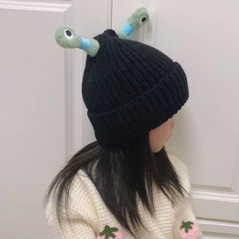 Studio shot of a yellow knit monster beanie, highlighting its quality