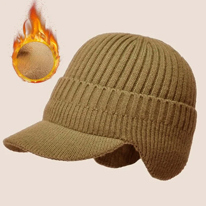 Close-up of the soft acrylic material on a blue knit beanie with ear protection.