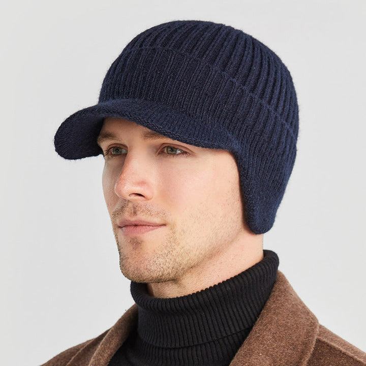 Textured shot of a chunky knit beanie hat in green, perfect for ear warmth.