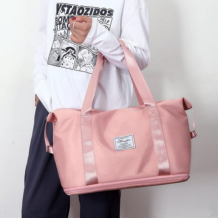 Unisex carry-on duffel bag in a light grey, featuring dry wet separation design