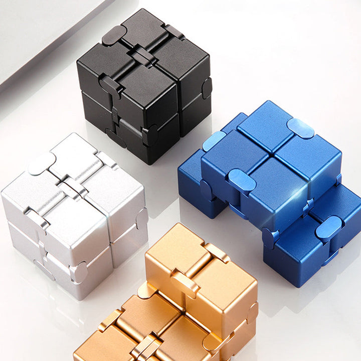 Hand holding an Infinity Fidget Stress Relief Cube, highlighting its compact size