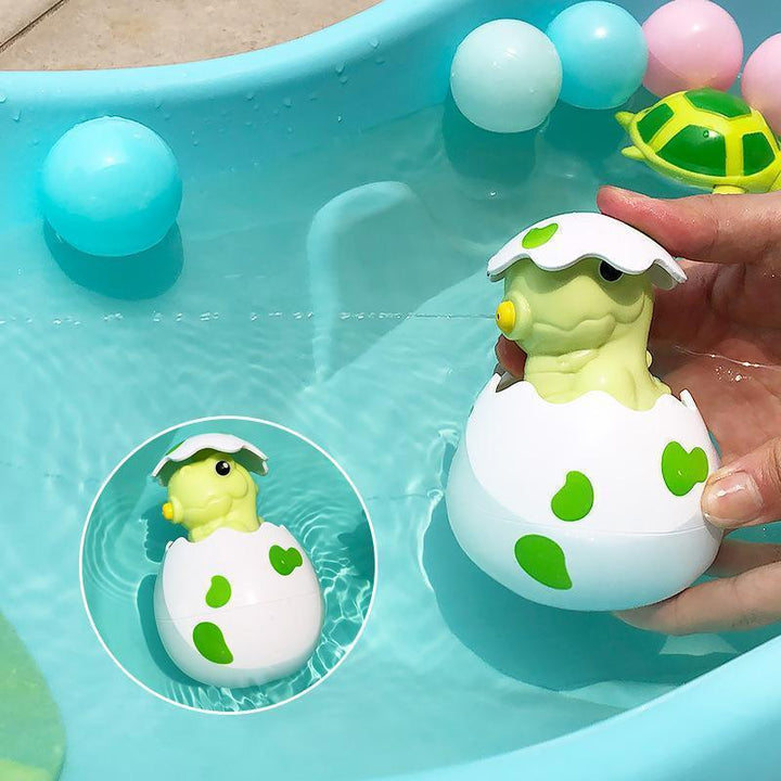 Parents and child enjoying playtime with the Floating Bath Sprinkler Toy, promoting early development
