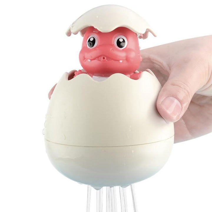 Educational bath toy: Floating Sprinkler with gentle water streams entertaining a baby in the tub