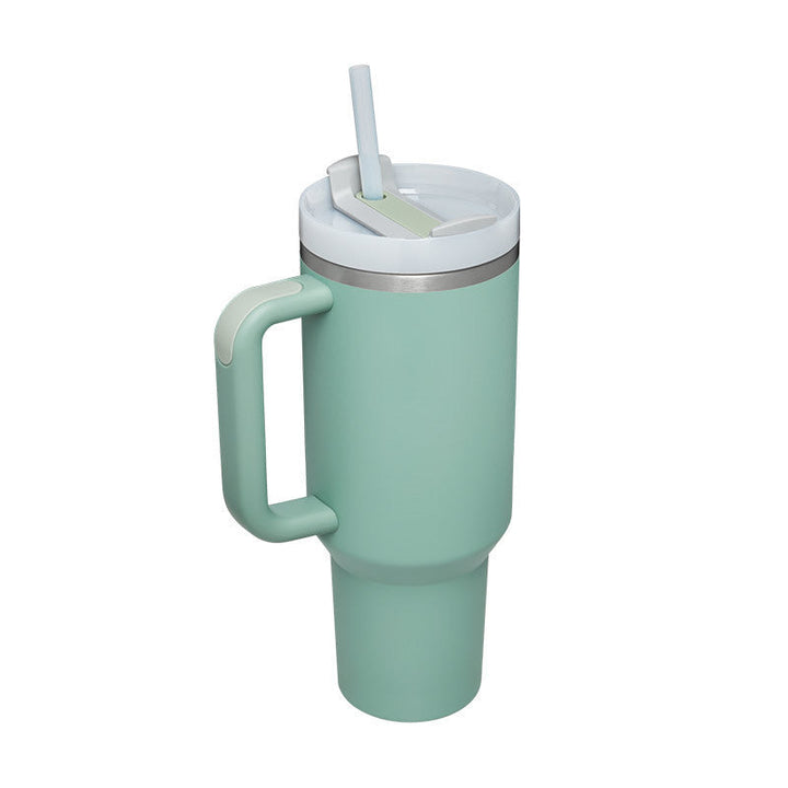 Durable insulated travel cup with handle & straw for hot & cold drinks.