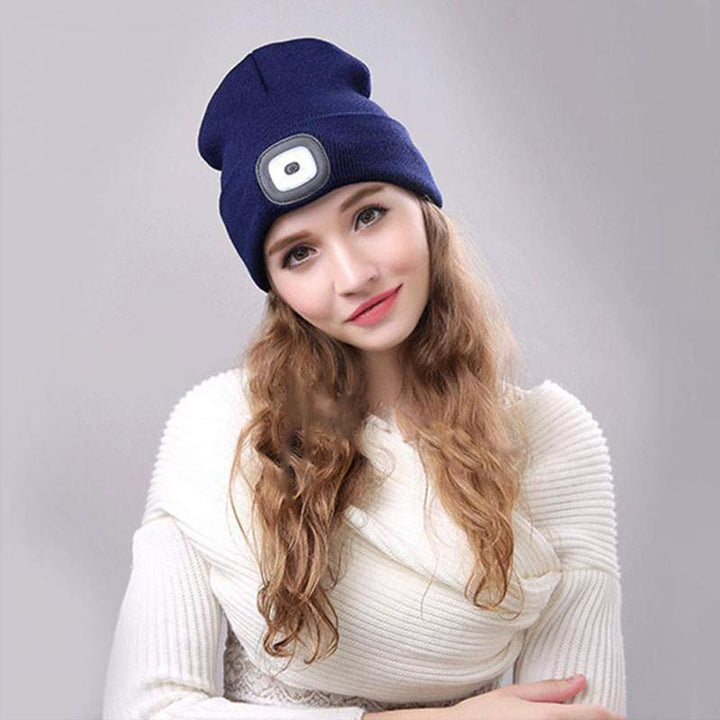 LED knitted winter beanie hat on a snowy trail, demonstrating hands-free lighting for winter adventures