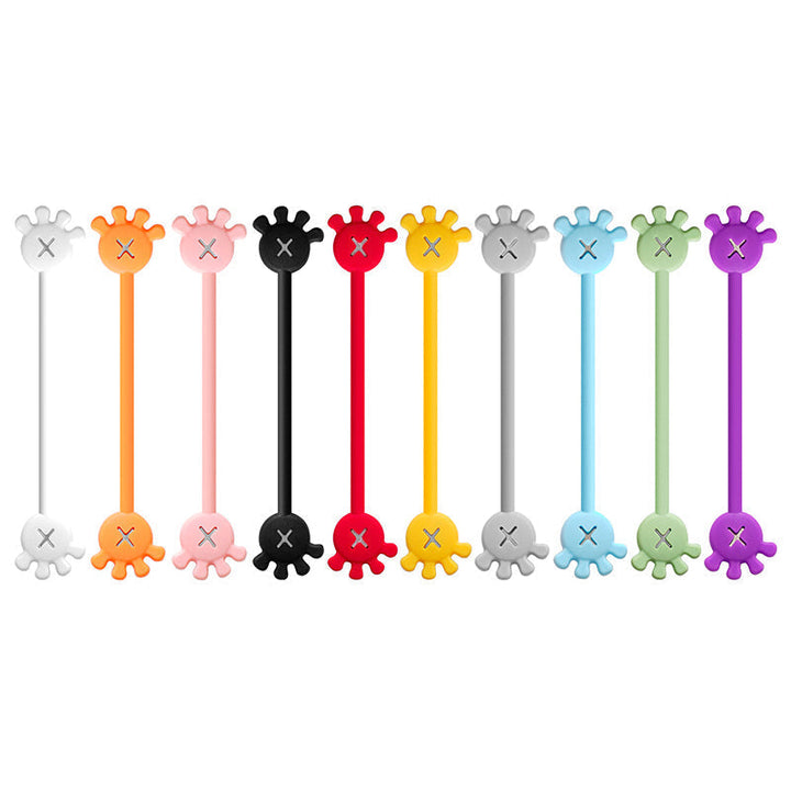 Assorted magnetic silicone cable organizer clips on a bulletin board, demonstration of magnetic strength.