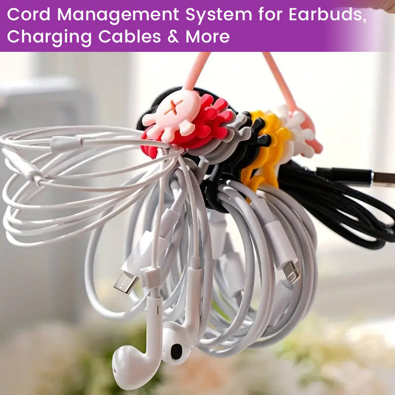 Magnetic silicone cable organizer clip in black, attached to metal, managing a headphone cord.
