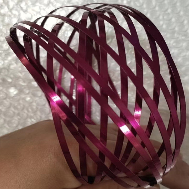 Detail shot of the unique spiral mechanism on a unisex metal fidget bracelet.