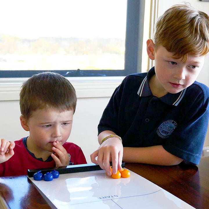 Kids and adults enjoy this mini curling tabletop game, a fun toy for family gatherings and indoor entertainment.
