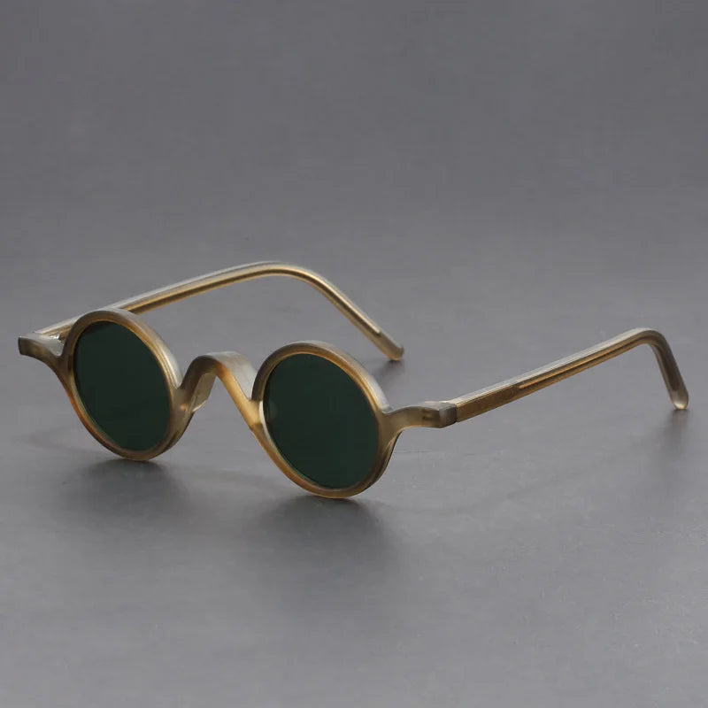 Unisex modern round sunglasses. Black frames, dark lenses, offering complete UV protection. Essential eyewear.