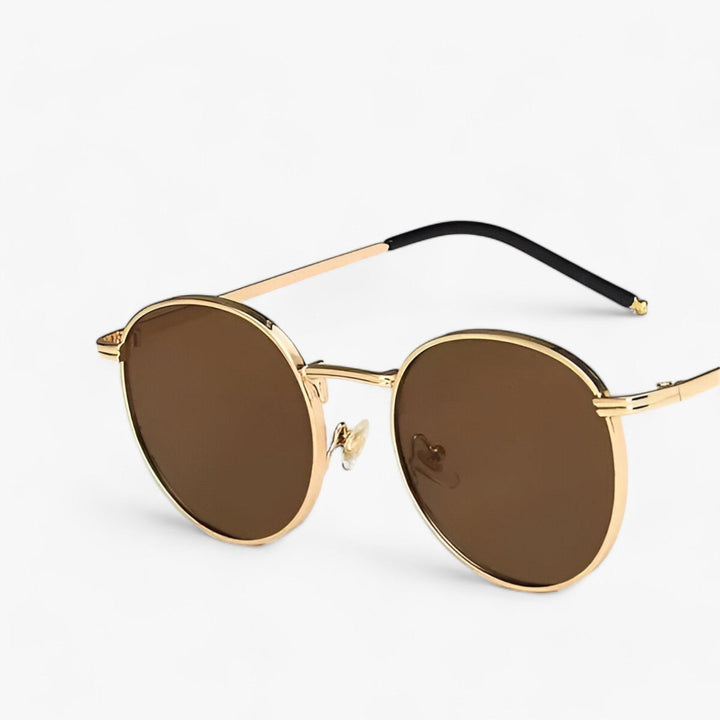 Black metal frame designer round sunglasses. Unisex fashion accessory offering full UV protection.