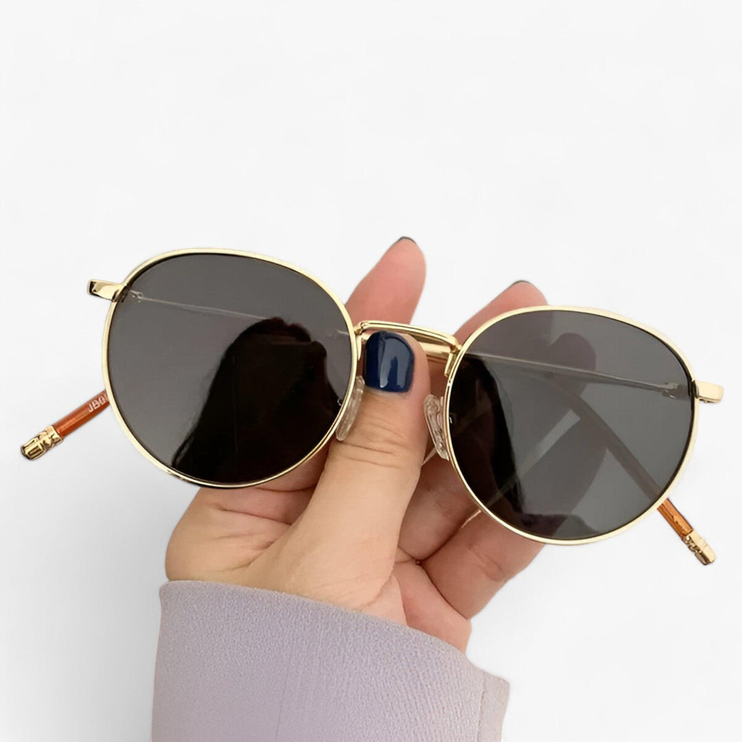Black Nova round lens unisex designer sunglasses. A chic fashion accessory featuring UV protection & metal frame.