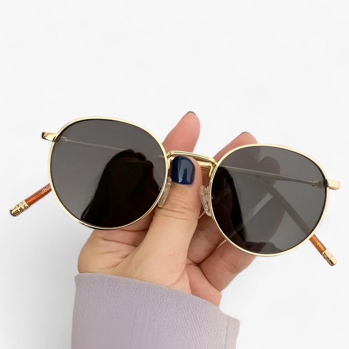 Black Nova round lens unisex designer sunglasses. A chic fashion accessory featuring UV protection & metal frame.