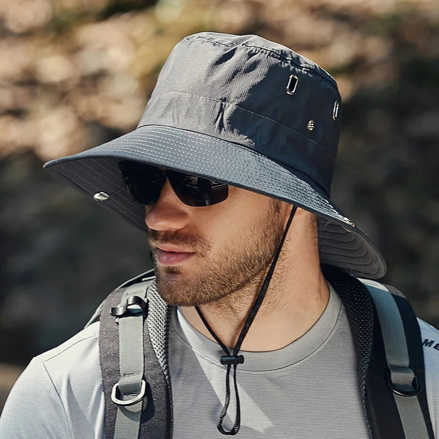 Close-up of a wide brim sun protection bucket hat, showing fabric texture and adjustable drawstring
