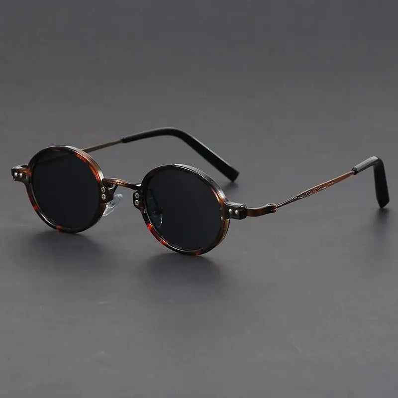 Unisex oval vintage sunglasses in black with precision lenses, a stylish eyewear accessory.