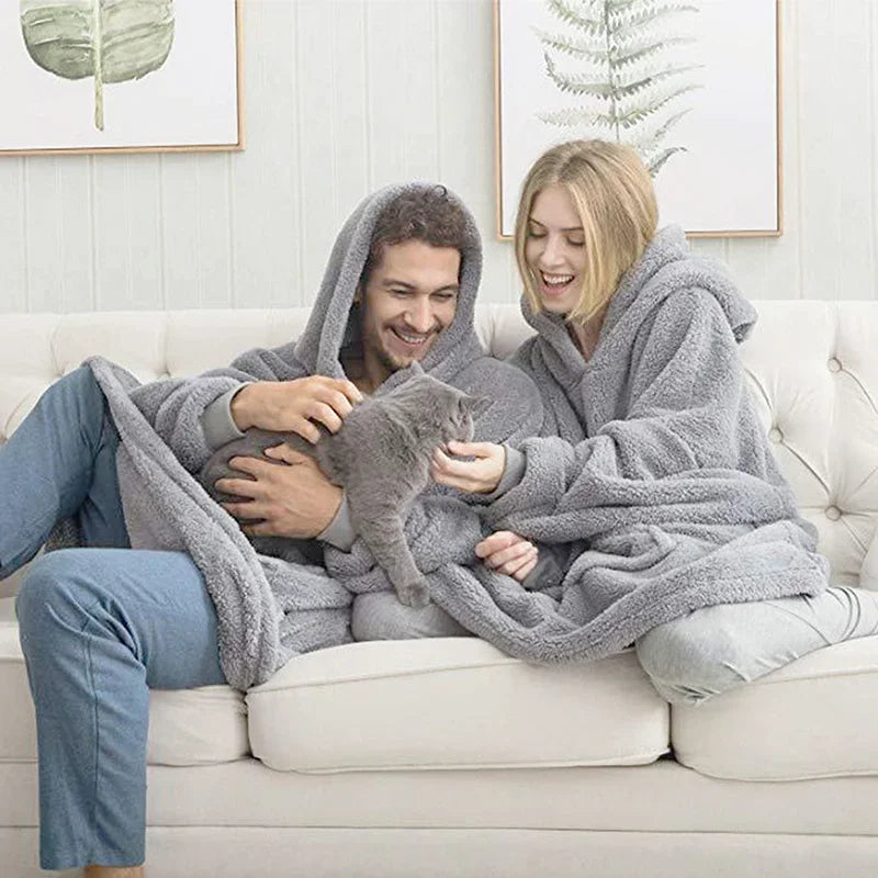Unisex oversized blanket hoodie in soft fleece, perfect for cozy comfort at home during winter.