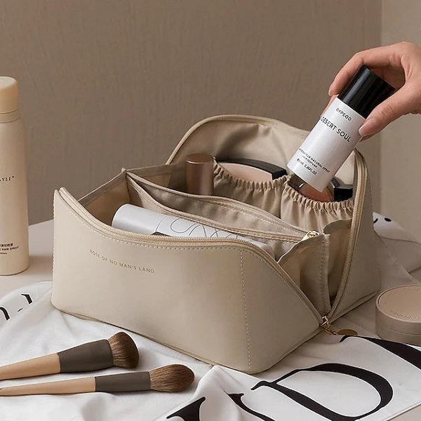 Overhead shot of a unisex waterproof cosmetic organizer, displaying all its functional storage compartments.