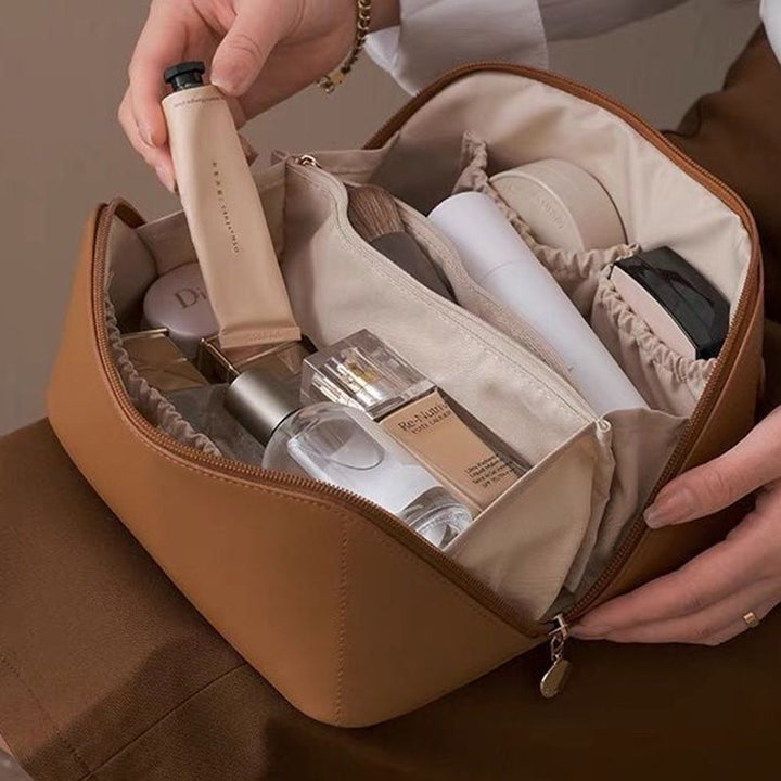 Folded compact design of a unisex waterproof travel cosmetic bag, ideal for men and women's toiletries storage.
