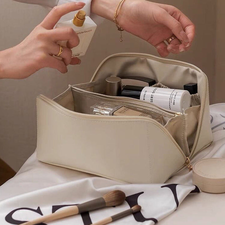 Open view of unisex travel cosmetic organizer showing multiple compartments for makeup and accessories.