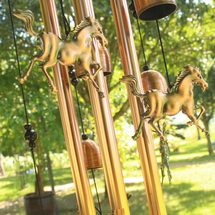Detail of the antique bronze finish on a retro animal wind chime, elegant garden and home decor