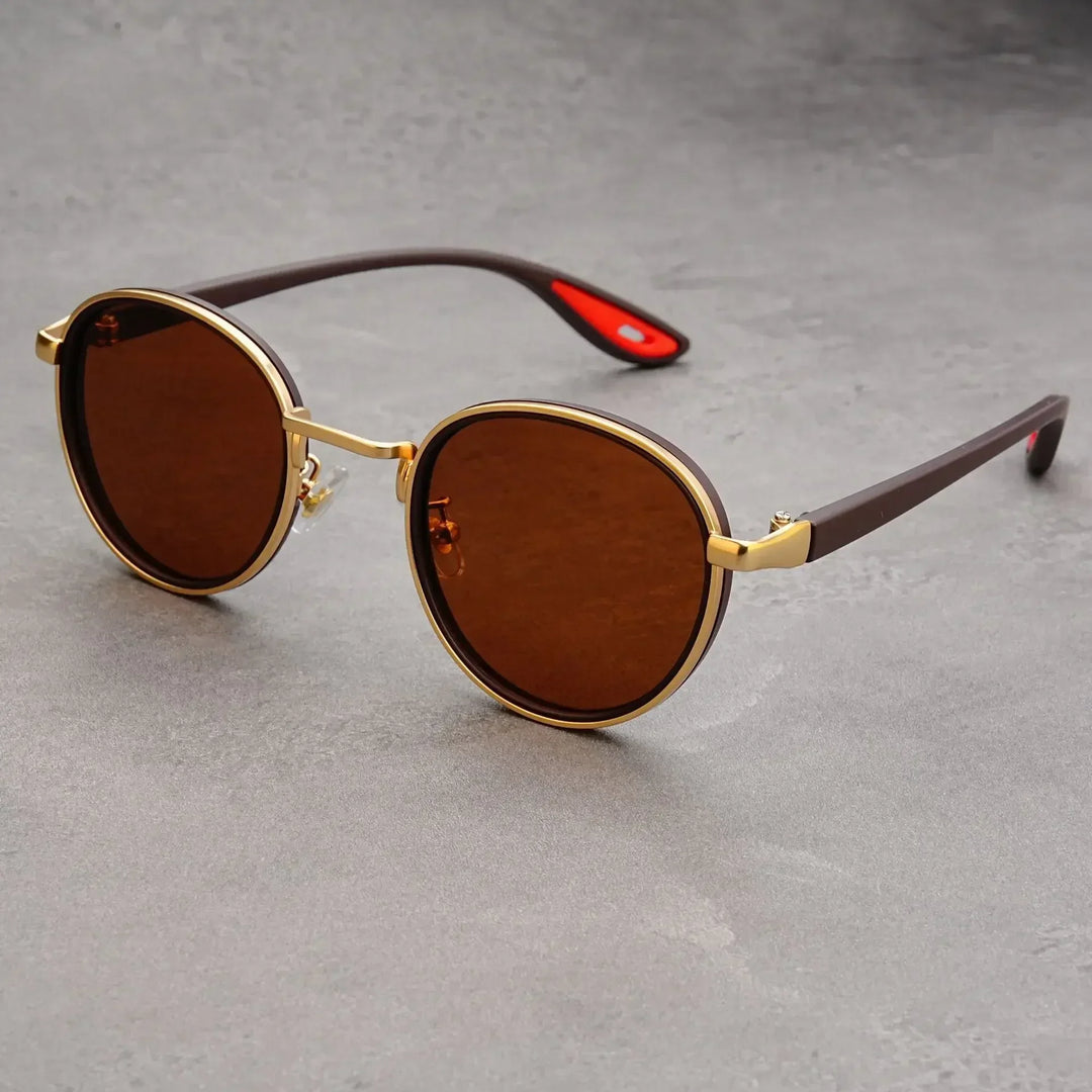Pair of classic retro round metal sunglasses with UV protective gradient lenses