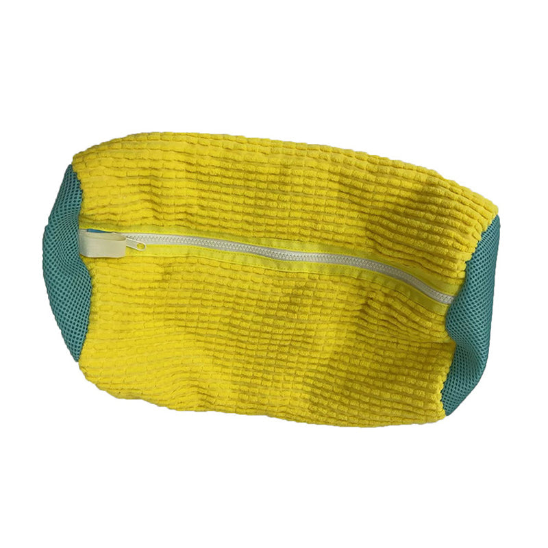 Unisex reusable laundry shoe wash bag containing dirty work boots, illustrating its protective function