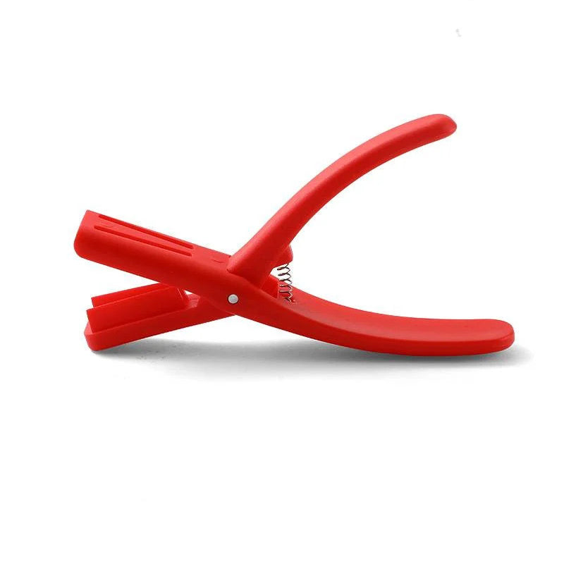 Red plastic Seafood Sheller Tool, showcasing its lightweight and easy-to-use design for seafood